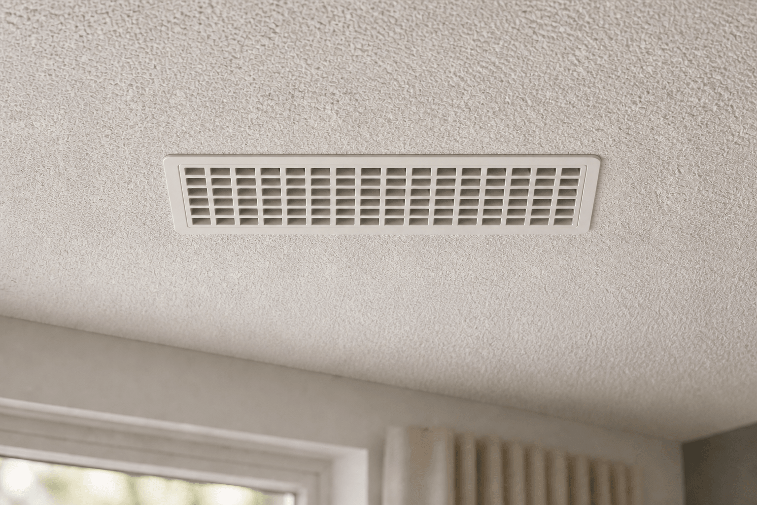 White Air Sensei smart vent installed in a textured ceiling