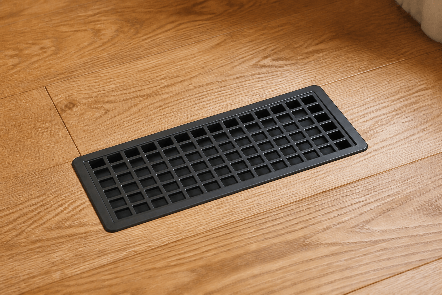 Black Air Sensei smart vent installed flush in a hardwood floor